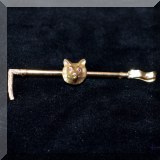 J14. Gold fox and crop pin with ruby eyes. 